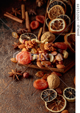 Dried fruits and nuts on a brown vintage background. Dried fruits and nuts on a brown vintage background. 143723149