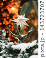 Christmas tree with white star, ornaments and warm fairy lights, festive illuminated background 143723707