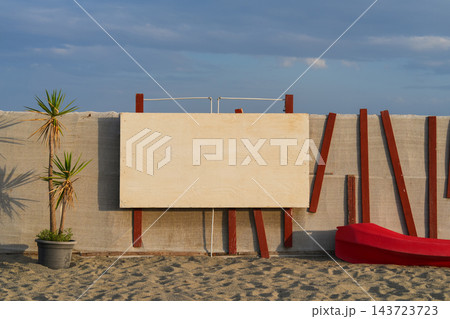 Blank plywood board on beach fence with copy space 143723723