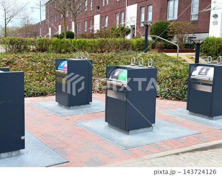 Underground waste containers for recycling in residential area. Underground waste containers for recycling in residential area. 143724126