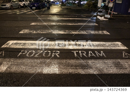 Pedestrian crossing on a tram line in a city at night 143724369
