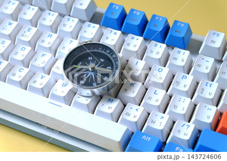 Vintage compass on computer key board ,business decision. 143724606