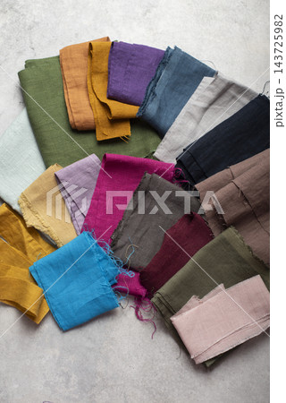 An assortment of colorful natural linen fabric scraps and swatches 143725982