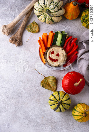 Halloween healthy snack Hummus in shape on pumpkin jack-o-lanter Halloween healthy snack Hummus in shape on pumpkin jack-o-lanter 143726394