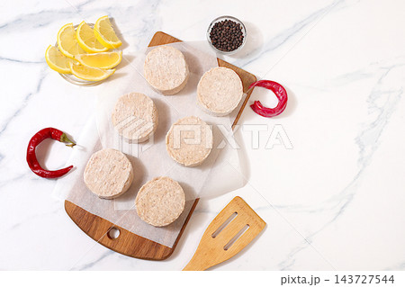 Frozen raw patties for quick preparation made from ground beef and pork featuring onion, tomato, lemon, garlic, recipe for delicious schnitzels and beef steaks, menu options for cafe or restaurant, 143727544