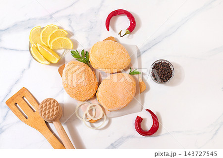 Frozen raw patties for quick preparation . Soy meat patties,vegetarian and vegan food, onion, tomato, lemon, garlic,recipe for appetizing schnitzels and beef steaks, menu options for cafe 143727545