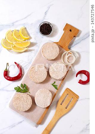 Frozen raw patties for quick preparation made from ground beef and pork featuring onion, tomato, lemon, garlic, recipe for delicious schnitzels and beef steaks, menu options for cafe or restaurant, 143727546