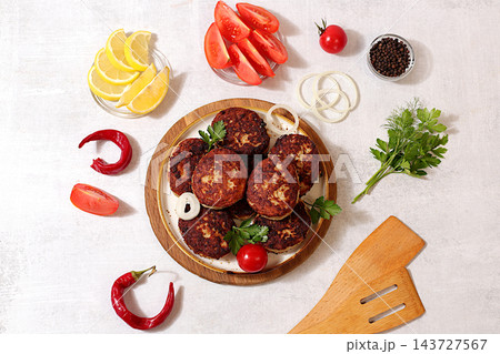 Homemade patties made from ground beef and pork featuring onion, tomato, lemon, garlic, recipe for delicious schnitzels and beef steaks, menu options for cafe, banner for fastfood establishment Homemade patties made from ground beef and pork featuring onion, tomato, lemon, garlic, recipe for delicious schnitzels and beef steaks, menu options for cafe, banner for fastfood establishment 143727567