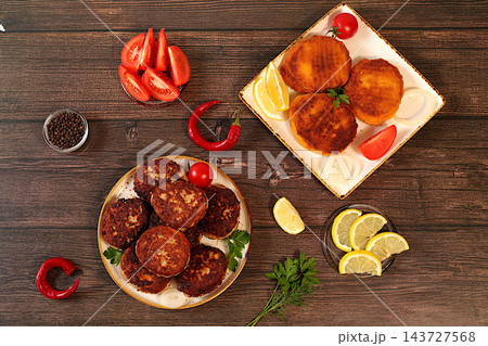 Homemade patties made from a variety of minced meats, seasoned with onion, tomato, lemon, garlic, and pepper , recipe for appetizing schnitzels and beefsteaks, banner for fastfood establishment. Homemade patties made from a variety of minced meats, seasoned with onion, tomato, lemon, garlic, and pepper , recipe for appetizing schnitzels and beefsteaks, banner for fastfood establishment. 143727568
