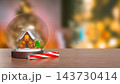 Magical Christmas Snow Globe with Cozy Winter House and Festive Decorations 3d render. 143730414