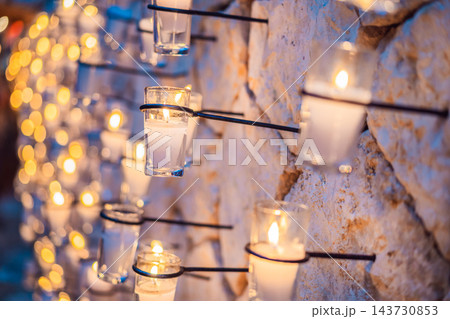 Votive candles creating a warm light display during a memorial tradition. Votive candles creating a warm light display during a memorial tradition. 143730853