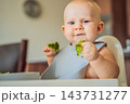 Baby reacting to the taste of broccoli during complementary feeding. 143731277
