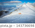 Cute striped mountain refuge on a snowy crest in winter 143736698