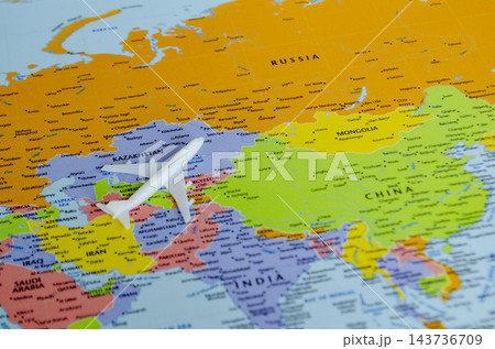 Toy Airplane Flying Over Continental World Map for Travel Planning Concept Toy Airplane Flying Over Continental World Map for Travel Planning Concept 143736709