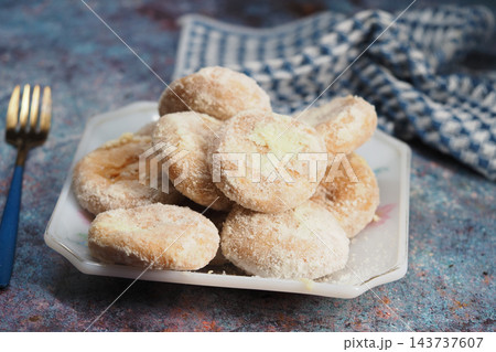 Sugar-coated pastries served on a plate at a table 143737607