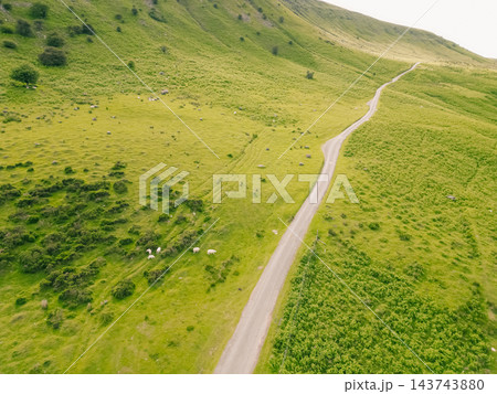 Aerial view of a scenic mountain valley with a winding road through the rugged landscape of Brecon Beacons National Park in Wales, United Kingdom Powys, Wales - 28 August 2026. Aerial view of a scenic mountain valley with a winding road through the rugged landscape of Brecon Beacons National Park in Wales, United Kingdom Powys, Wales - 28 August 2026. 143743880