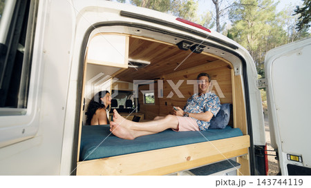 Mature couple enjoying van life in camper van Mature couple enjoying van life in camper van 143744119