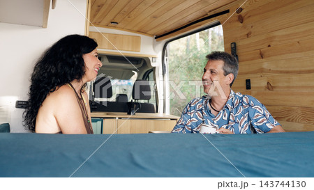 Mature couple enjoying travel and freedom in camper van Mature couple enjoying travel and freedom in camper van 143744130