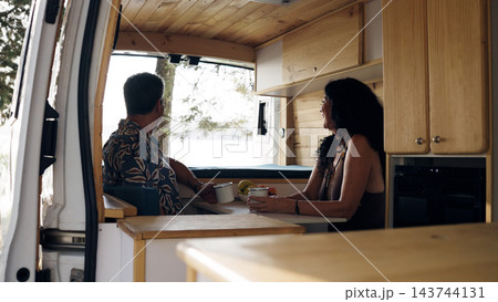 Mature couple enjoying van life in a camper van 143744131