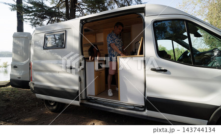 Mature couple enjoying van life road trip adventure Mature couple enjoying van life road trip adventure 143744134