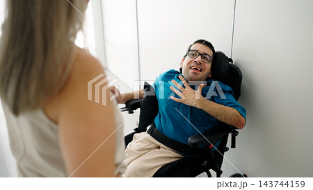 Disabled man with cerebral palsy in wheelchair talking Disabled man with cerebral palsy in wheelchair talking 143744159