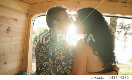 Mature couple sharing romantic moment inside camper van Mature couple sharing romantic moment inside camper van 143744856