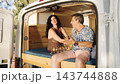 Mature couple enjoying camper van road trip lifestyle 143744888