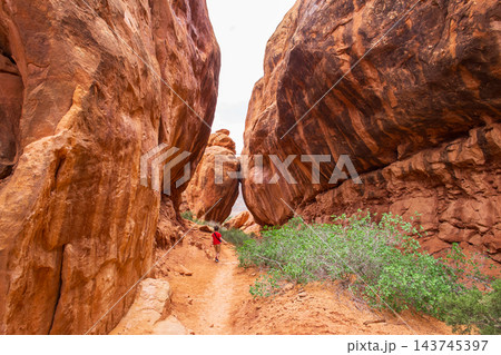 Young Hiker Exploring Fiery Furnace Trail in Utah 143745397
