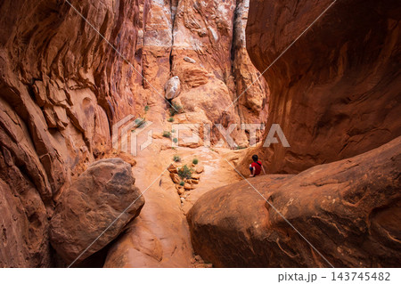 Young Hiker Exploring Fiery Furnace Trail in Utah Young Hiker Exploring Fiery Furnace Trail in Utah 143745482