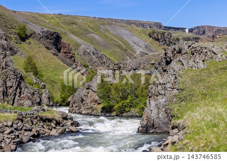 River rapids in a rocky gorge below distant Hengifoss waterfall, East Iceland River rapids in a rocky gorge below distant Hengifoss waterfall, East Iceland 143746585