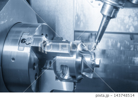 Automotive parts production on a multi-tasking CNC machine using a ball nose end mill in a blue tone scene 143748514