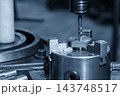 Internal thread making process on a  milling machine using a tapping tool in a blue tone scene 143748517