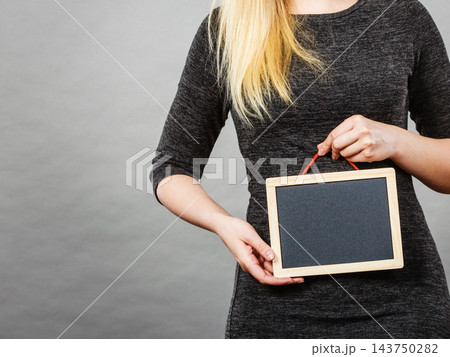 Woman holding blank black board on stomach 143750282