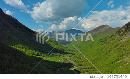 Rocky snow mountains and green valley aerial Rocky snow mountains and green valley aerial 143751449