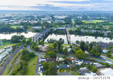 Aerial view of a train and pedestrian bridge across the Nepean River in Penrith Aerial view of a train and pedestrian bridge across the Nepean River in Penrith 143751570