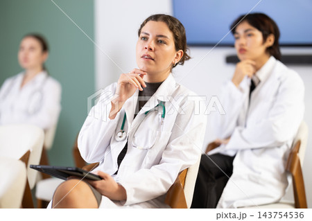 young woman participates in a conference for young doctors young woman participates in a conference for young doctors 143754536