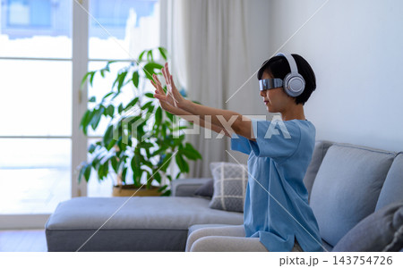 リビングでVR体験を楽しむ女性 143754726