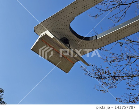 Overhead charging plate seen from below against blue sky Overhead charging plate seen from below against blue sky 143757787