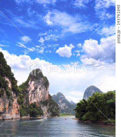 Famous tourist attraction - traditional river cruise near Yangshuo, Guangxi, China. Picturesque Landscape of Guilin, Li River and Karst mountains. Summer topic of travel, trip, vacation, tour 143761848