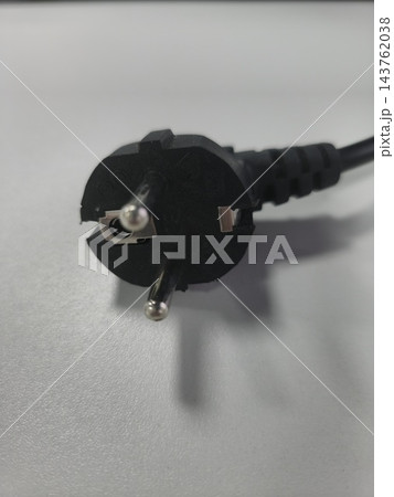 Black electrical power plug on light surface close up 143762038