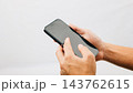 Man hand holding black smartphone mockup blank screen display, A hand holding a black cell phone isolated on white background 143762615