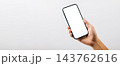 Man hand holding black smartphone mockup blank screen display, A hand holding a black cell phone isolated on white background 143762616