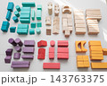 Colorful wooden building blocks scattered on white background for early childhood education 143763375