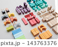 Colorful wooden building blocks scattered on white background for early childhood education 143763376