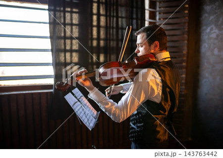 Portrait of a man playing violin Portrait of a man playing violin 143763442
