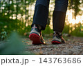 Close up of hiking shoes walking on forest trail 143763686