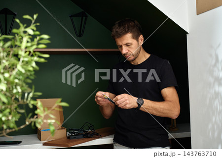 Man inspecting LED strip before installation 143763710