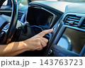 Hand pressing engine start button inside car 143763723