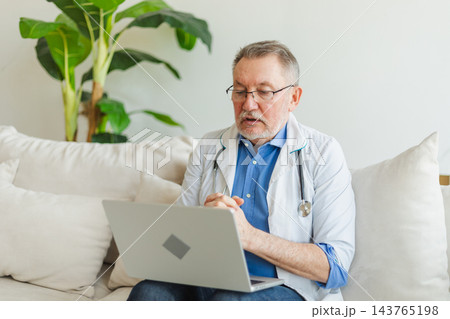 Senior man doctor with laptop talk on video call have consultation with patient. Professional senior mature healthcare expert examining patient online. Medicine healthcare medical checkup 143765198