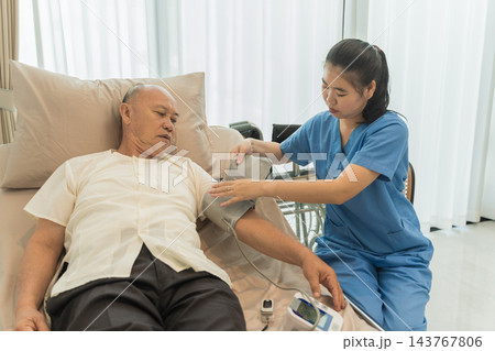 Senior man receiving health check from nurse in wellness care home. Senior man receiving health check from nurse in wellness care home. 143767806